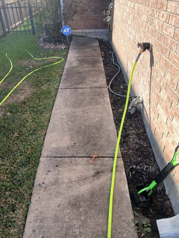 A hose connected to the wall of a house.