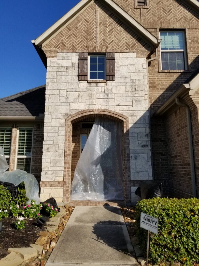 A house entrance covered with plastic sheeting for protection.