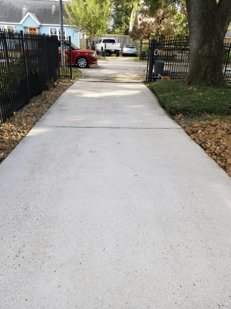 Newly paved concrete sidewalk in a residential area.